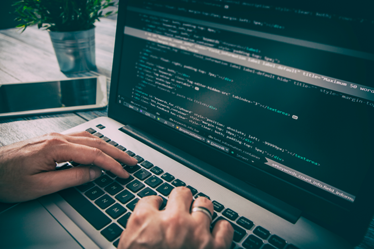 Hænder skriver kode på computer
